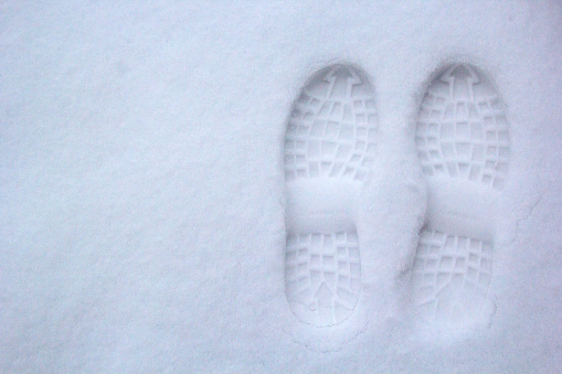 Сouple of deep footstep on the fresh friable snow