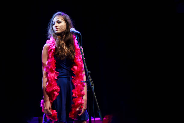 istock Young girl singing on stage 899342970