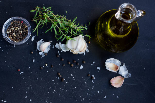 istock Fresh Herbs, Garlic, Pepper and Olive Oil  on Black Background 899346566