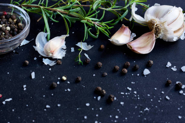 istock Fresh Herbs, Garlic, Pepper and Olive Oil  on Black Background 899347636