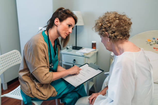 Female doctor filling out a questionnaire stock photo