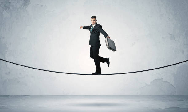 istock Sales guy balancing on tight rope 899350890