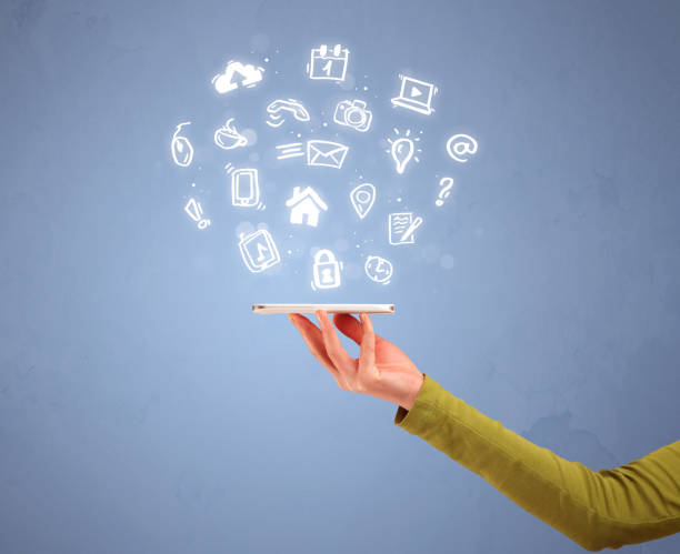 istock Hand holding tablet phone with drawn icons 899352114