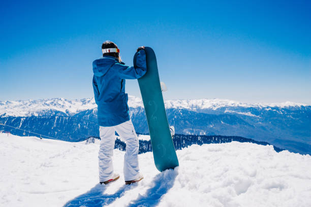 istock young  snowboarder woman 899352246