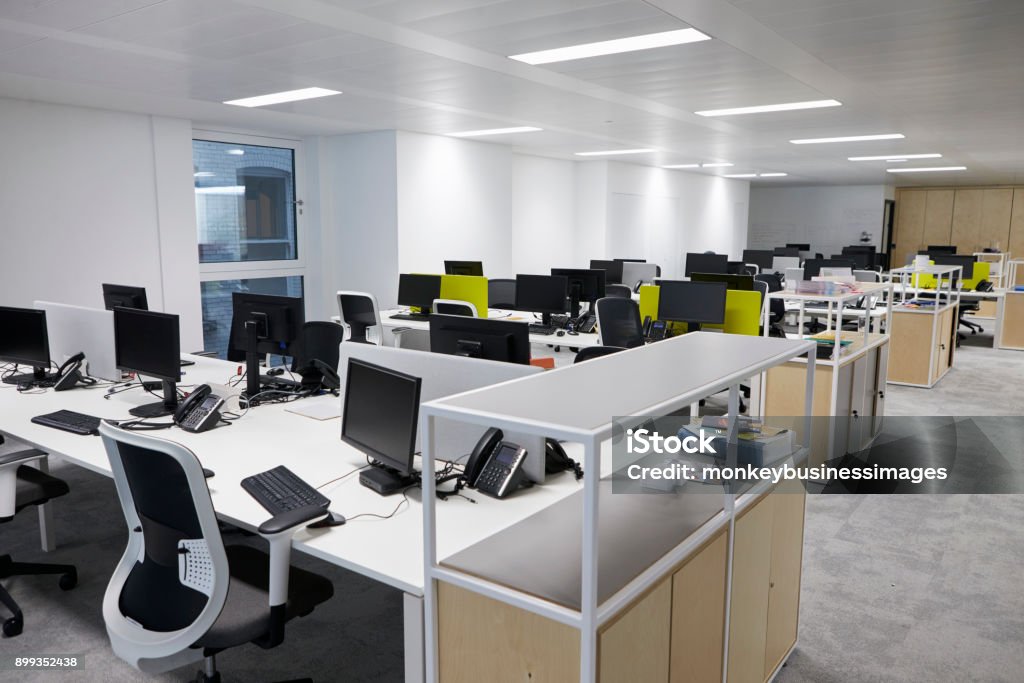 Empty open plan office with multiple work stations Office Stock Photo