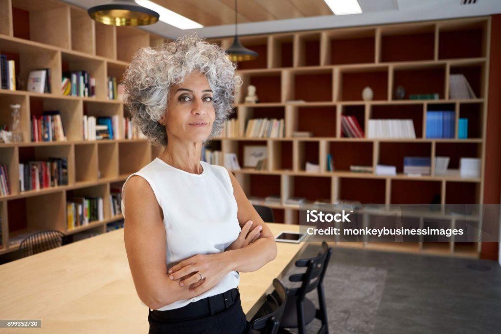 Senior businesswoman standing in boardroom looking to camera Businesswoman Stock Photo