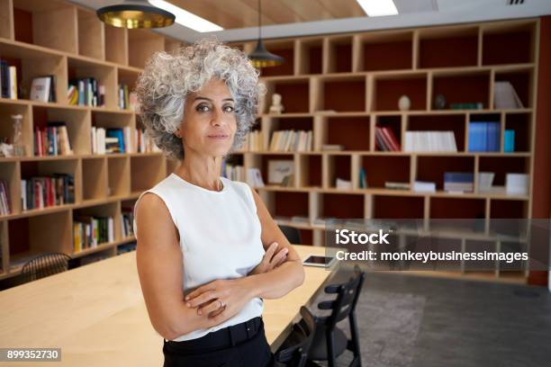 Senior Businesswoman Standing In Boardroom Looking To Camera Stock Photo - Download Image Now
