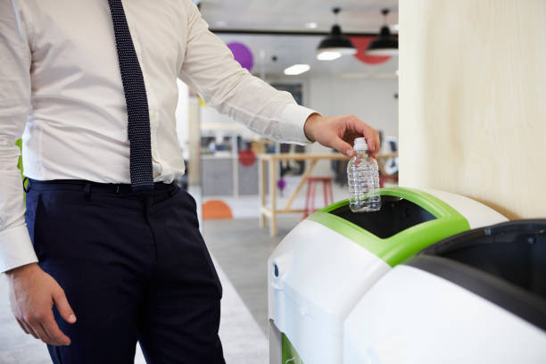 istock Man in an office recycling plastic bottle, close up 899355226
