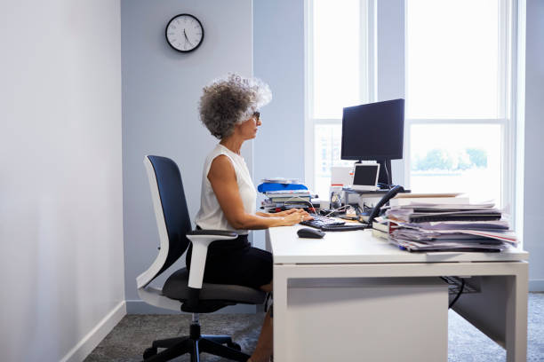 istock Middle aged businesswoman using laptop computer in her office 899355428