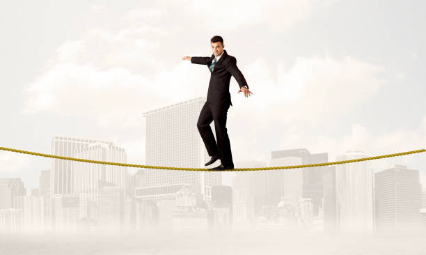 istock Business person balancing on golden rope 899355478