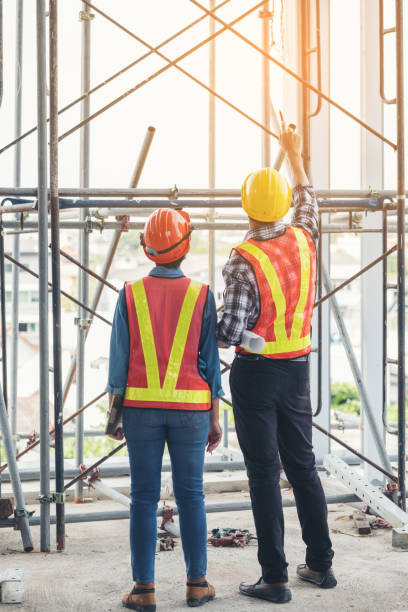 istock Group engineers and architects are discussing the construction. Helmet blueprint for use in construction and industrial engineering. Image of engineer meeting for architectural project, Construction concept. 899362662