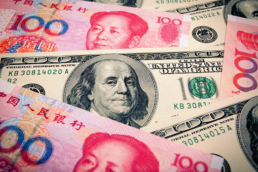 Chinese Yuan Note and U.S. dollar background