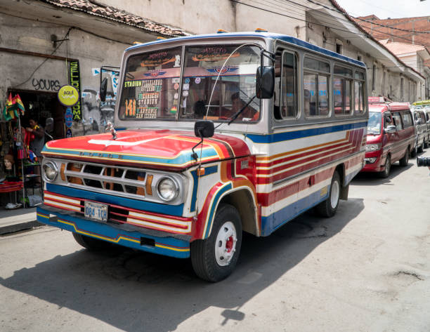 public transport bus go down a street in la paz, bolivia - bustrip imagens e fotografias de stock