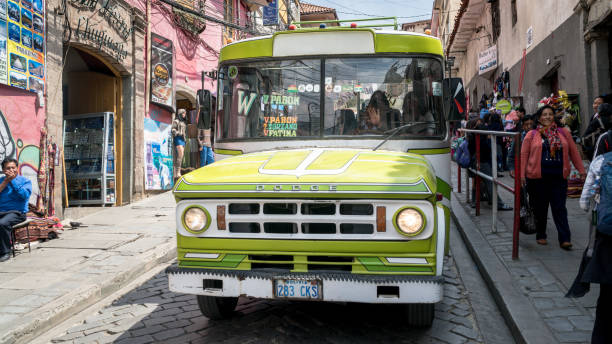 public transport bus go down a street in la paz, bolivia - bustrip imagens e fotografias de stock