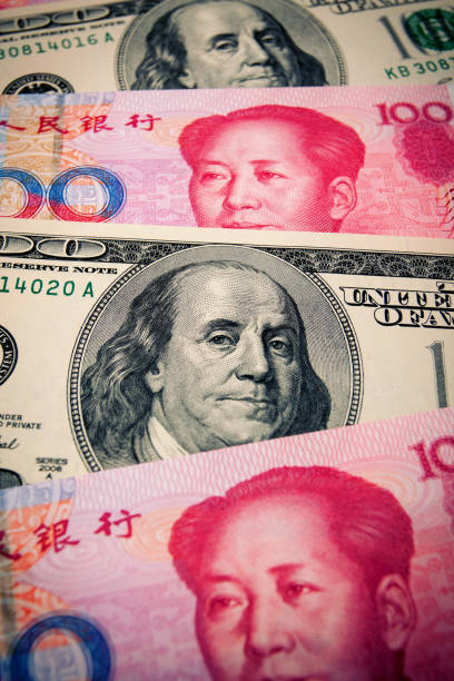 istock Chinese Yuan Note and U.S. dollar background 899363292