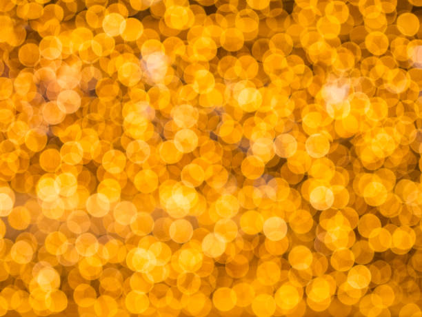 istock golden yellow blurred bokeh light defocused background and textured 899365574