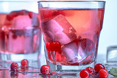 closeup of a cape cod cocktail or vodka cranberry on a blue background