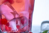 closeup of a cape cod cocktail or vodka cranberry on a blue background