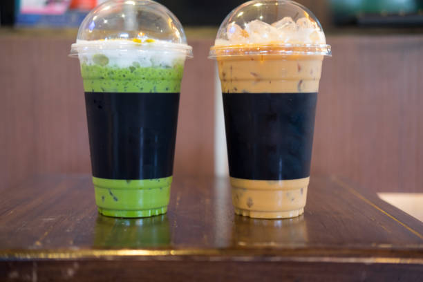 istock Selective focus ice coffee and ice green tea on wood table 899374120