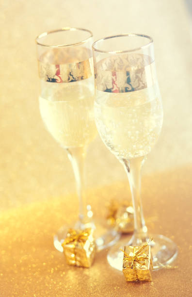 istock New Year golden champagne glasses background 899374148