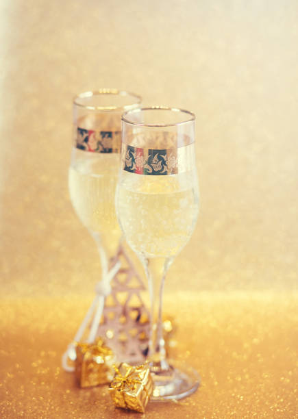 istock New Year golden champagne glasses background 899374220