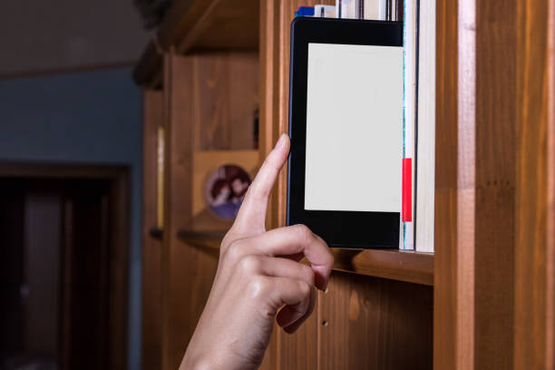 Female hand taking an eBook from a bookshelf.