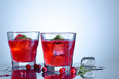 closeup of a cape cod cocktail or vodka cranberry on a blue background