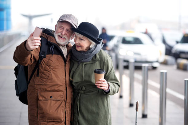 istock Pleasant senior couple are making picture using phone 899380316