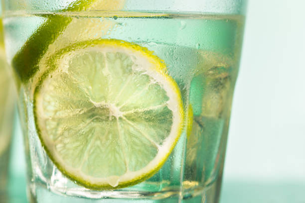 The closeup of a cape cod cocktail or vodka with fruits on blue studio background