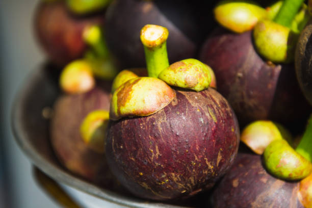 istock Mangosteen on the scales 899380836