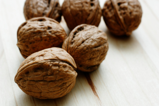 group of walnuts on an oak table