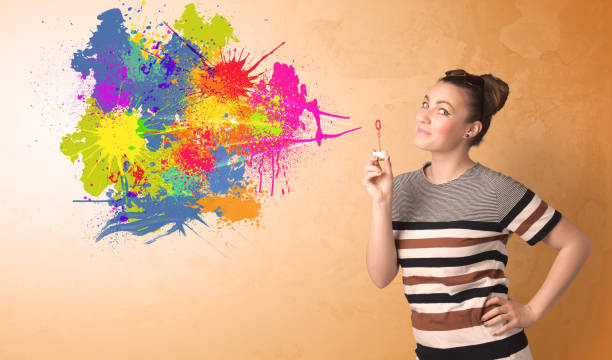 istock Cute girl blowing colorful splash graffiti 899389088