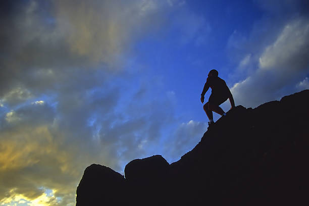 istock silhouette man hiker on steep mountain ridge with sunset sky 89939017