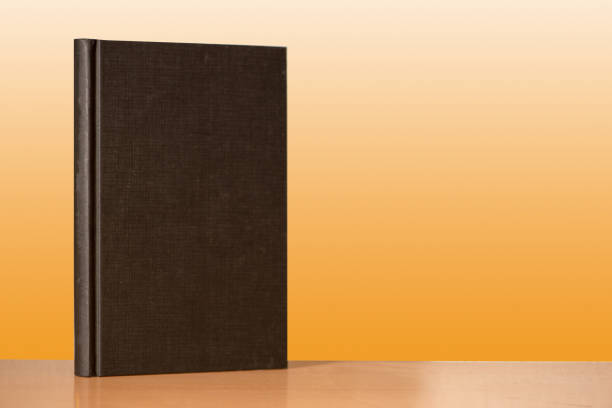 istock Some books on a table with golden background 899392902
