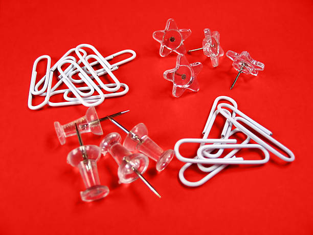 istock Paper clips and push pins over red background 89939873