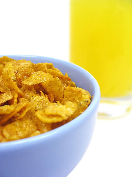 Bowl of cereal and orange juice stock photo