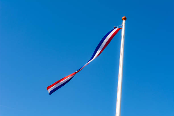 Dutch red , white and blue pennant against clear blue sky