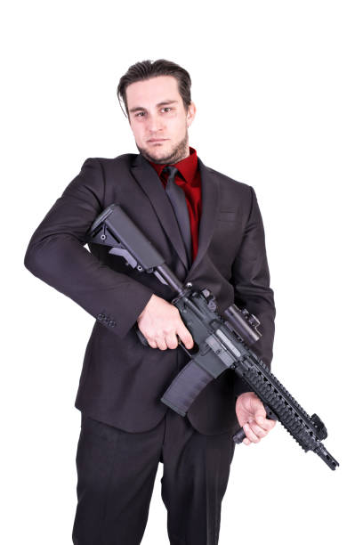 istock Elegant gangster holding rifle gun. 899402218