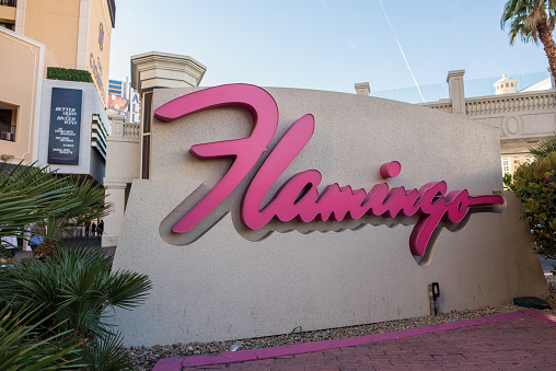 Las Vegas, Nevada, November 23, 2017: The pink cursive sign at the entrance to the historic Flamingo hotel and casino on the Las Vegas Boulevard strip. Millions visit Las Vegas yearly.