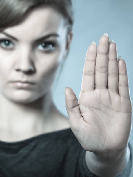istock Female shows stop sign by her hand. 899406120