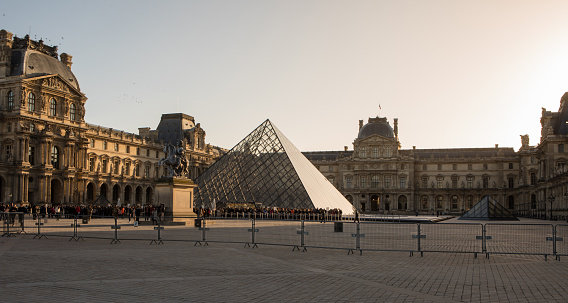Paris, France - October 30, 2017: View of main courtyard of Louvre Museum with Louvre buildings and pyramid. Louvre Museum is one of largest and most visited museums worldwide.