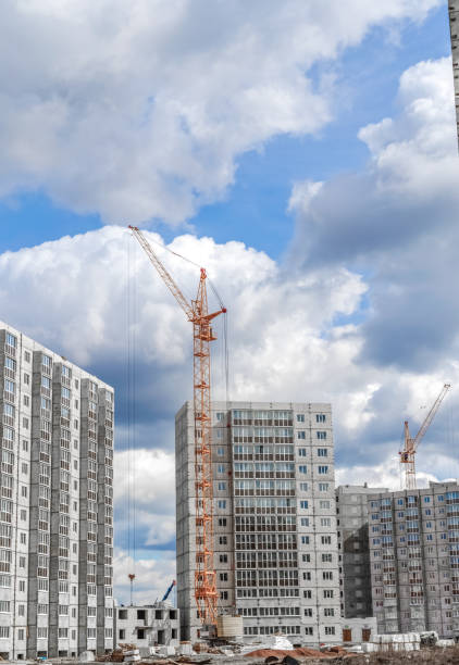 istock Industrial cranes and new highrise building 899407786