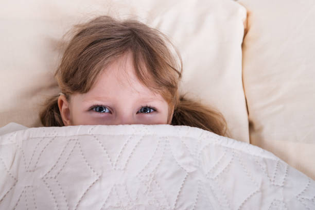 istock Child looks out of a blanket 899410140