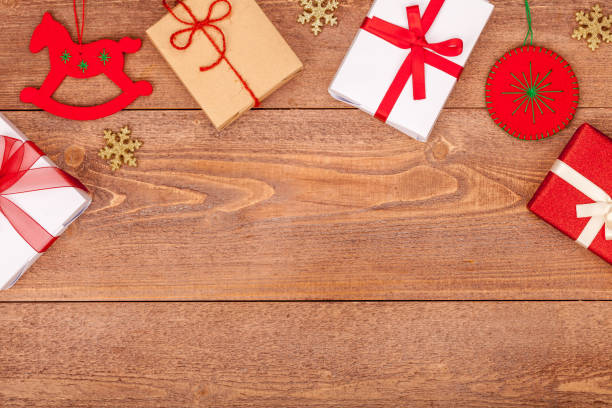 istock christmas background with decorations and gift boxes on wooden table, top view, copyspace 899414342