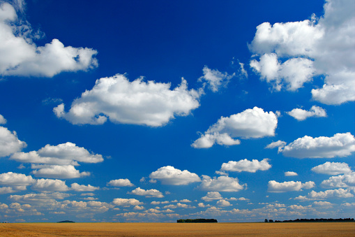 Stubble field, cloudy sky above