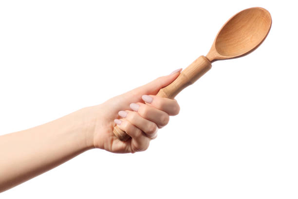 istock Kitchen wooden spoon in hands 899418406