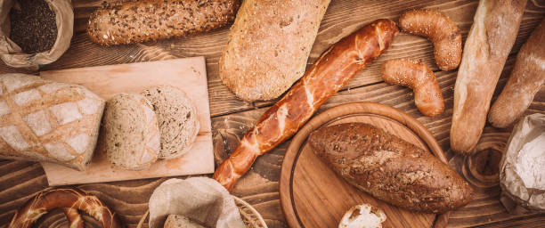 istock Many mixed baked breads and rolls on rustic wooden table 899419242