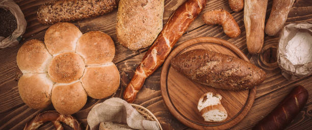 istock Many mixed baked breads and rolls on rustic wooden table 899419354