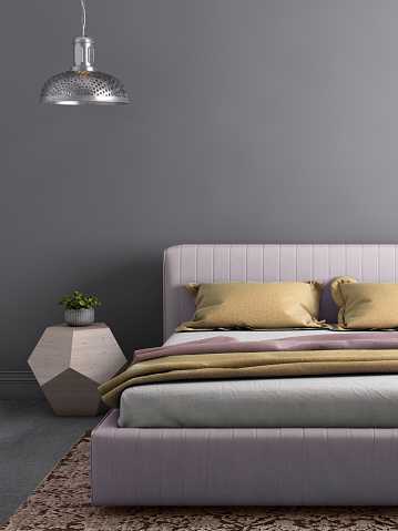Interior bedroom close up with bed, pastel colored pillows, modern nightstand and wall lamp. Copy space template
