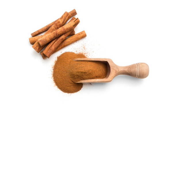 istock Cinnamon sticks and powder in a wooden scoop 899427356